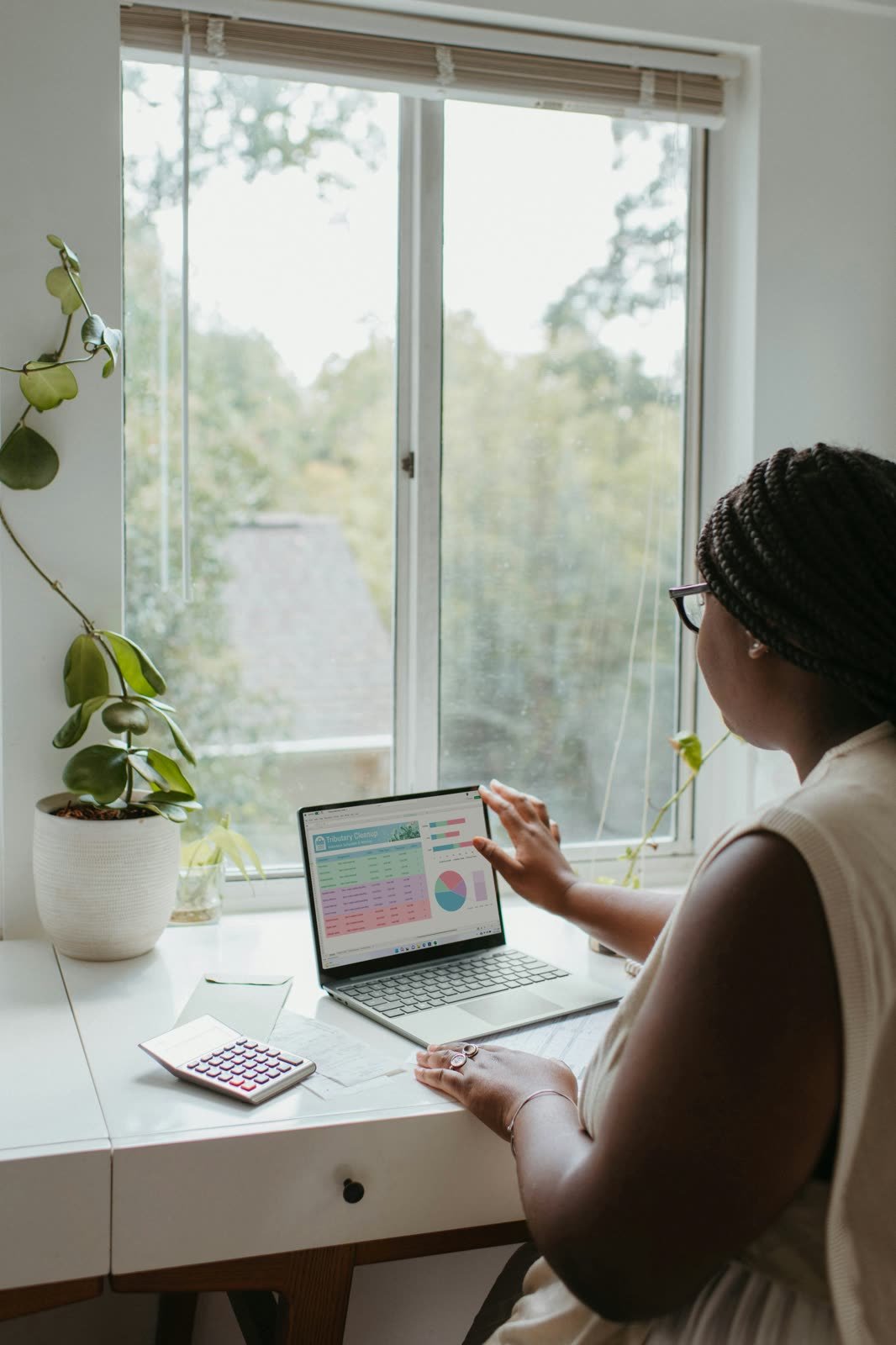 Person reviewing mortgage paperwork with a calculator